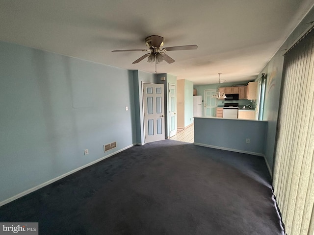 unfurnished living room with visible vents, dark carpet, baseboards, and ceiling fan