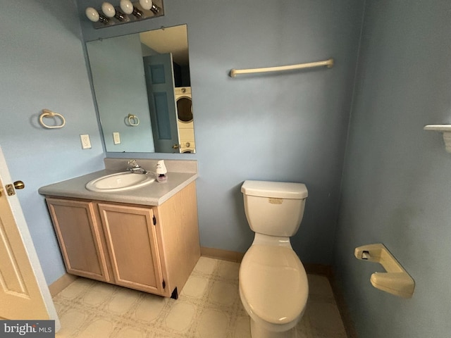 bathroom featuring baseboards, vanity, toilet, and tile patterned floors