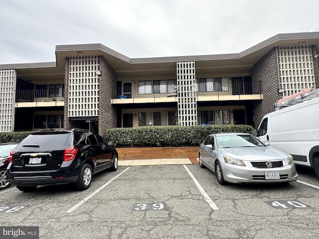 view of building exterior with uncovered parking