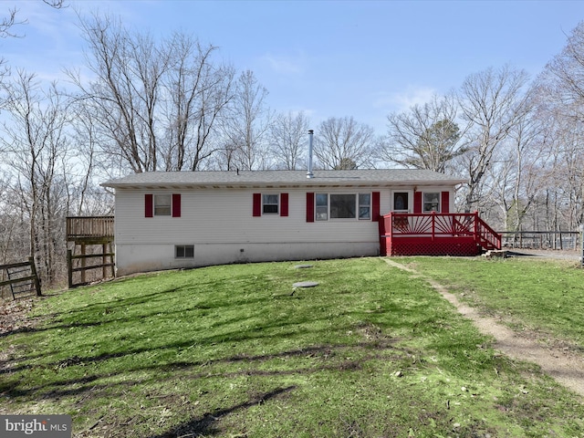 back of house with a lawn, a deck, and fence