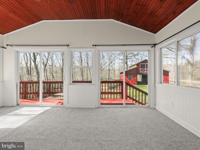 unfurnished sunroom with lofted ceiling, plenty of natural light, and wood ceiling