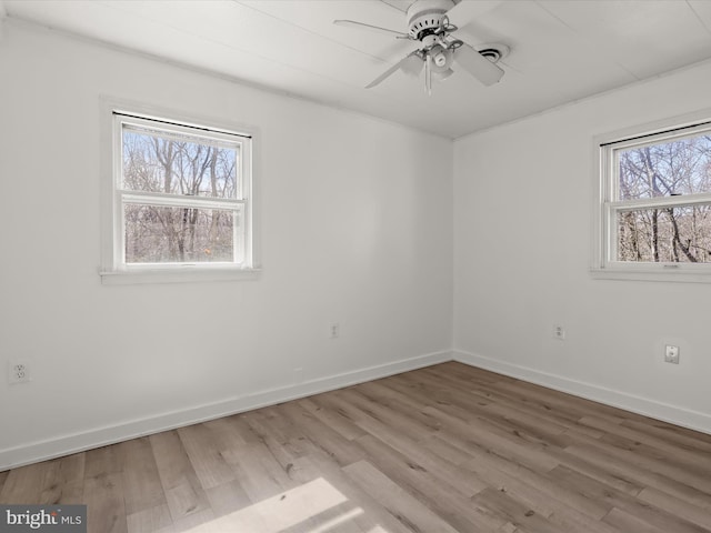 empty room with light wood-style flooring, baseboards, and ceiling fan