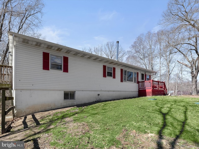 view of home's exterior with a lawn and a wooden deck