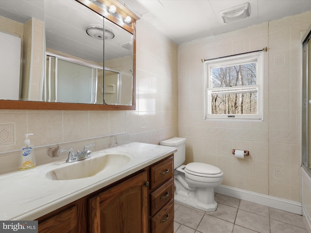 full bathroom with visible vents, a shower with shower door, tile patterned flooring, tile walls, and toilet