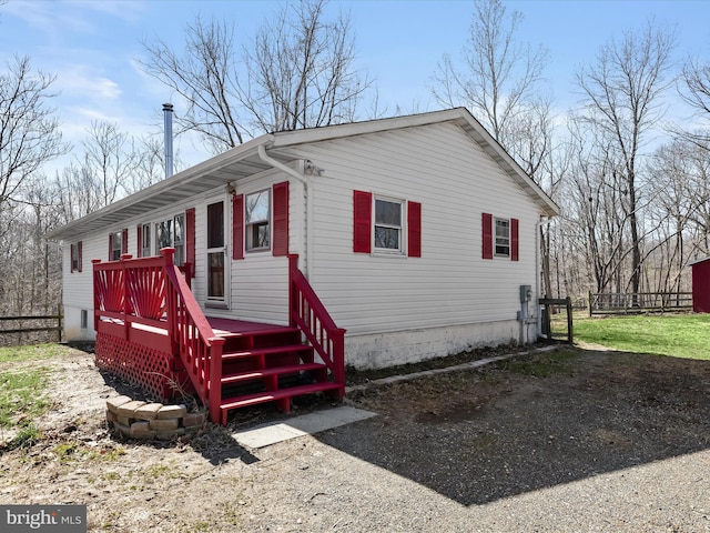 view of front of home featuring a wooden deck and fence