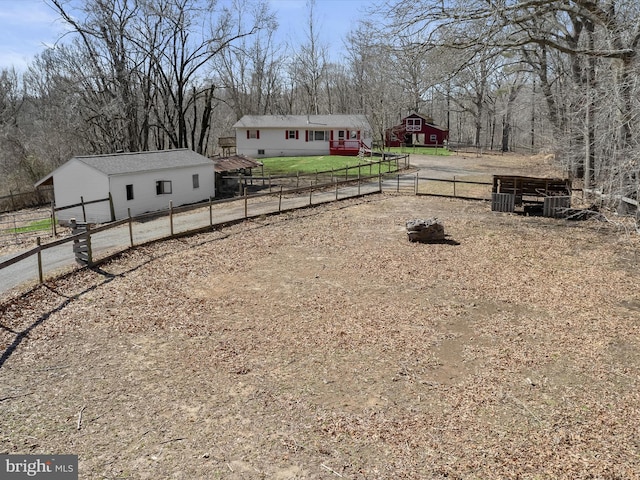 view of yard with an outbuilding and fence