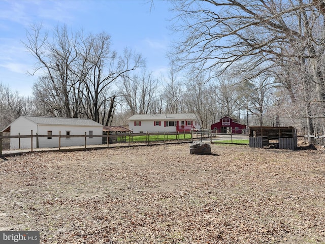 view of yard featuring an outbuilding and fence