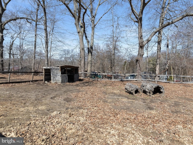 view of yard with an outdoor structure and fence