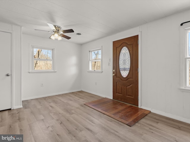 foyer with visible vents, baseboards, light wood-style flooring, and a ceiling fan