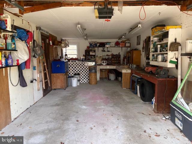 garage featuring a workshop area and a garage door opener