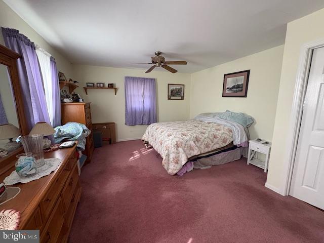 bedroom with dark carpet and ceiling fan