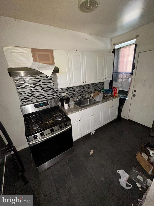 kitchen featuring a sink, white cabinets, backsplash, stainless steel range with gas cooktop, and range hood