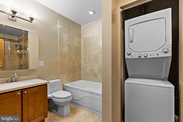 bathroom with tile patterned floors, toilet, vanity, and stacked washer and dryer