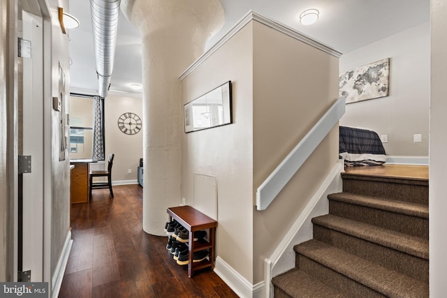 stairway featuring wood finished floors and baseboards