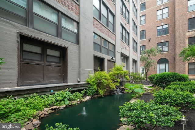 view of property with a small pond