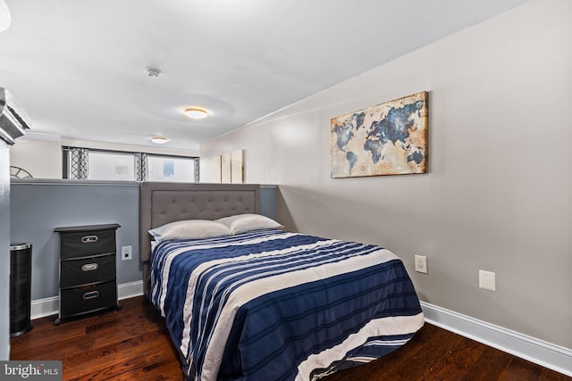 bedroom featuring wood finished floors and baseboards