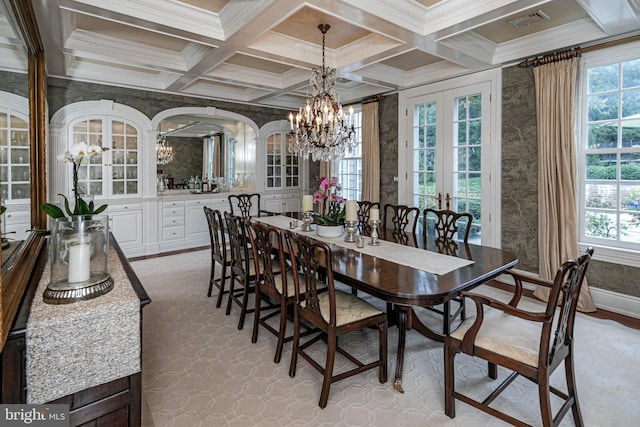 dining area with a wealth of natural light, french doors, visible vents, and beam ceiling