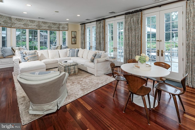 living area with dark wood finished floors, crown molding, and french doors