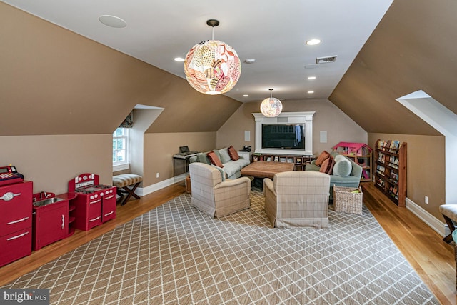 interior space featuring recessed lighting, wood finished floors, visible vents, baseboards, and vaulted ceiling