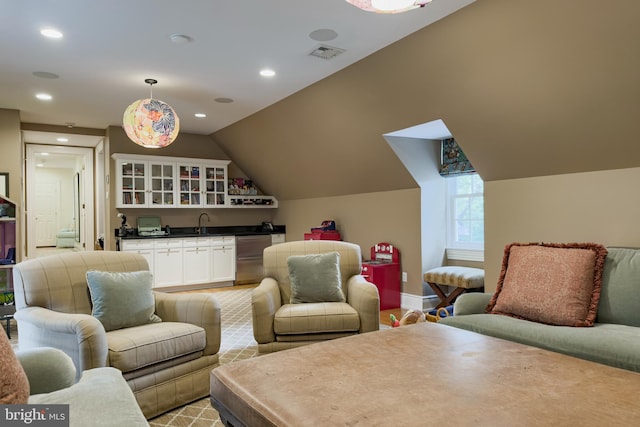 living room with lofted ceiling, recessed lighting, visible vents, wet bar, and baseboards