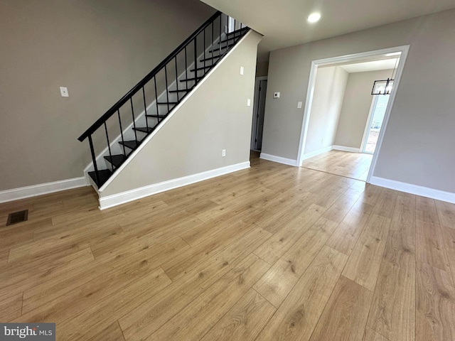 interior space with recessed lighting, visible vents, baseboards, stairway, and light wood finished floors