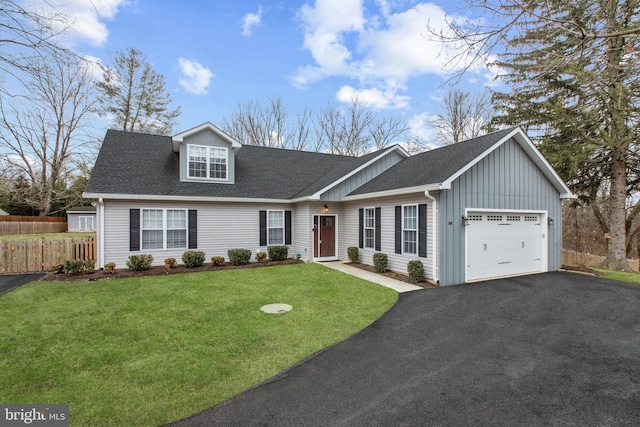 view of front of property featuring aphalt driveway, a garage, a front yard, and a shingled roof