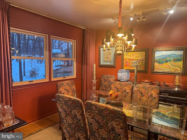 dining space with an inviting chandelier and wood finished floors