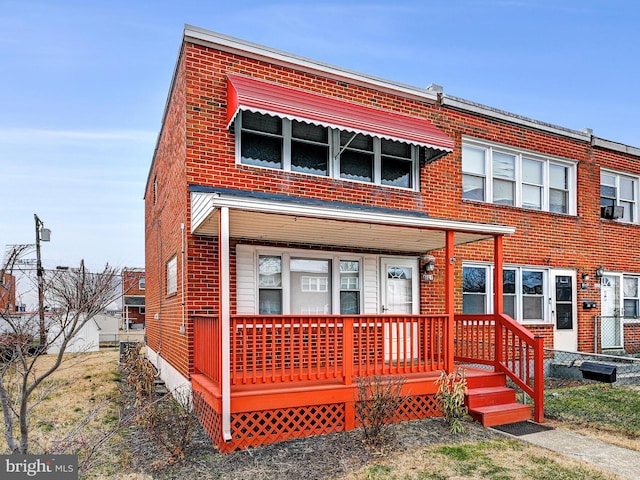 view of front facade with a porch and brick siding