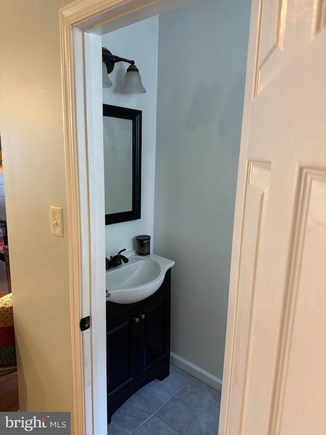 bathroom featuring vanity, tile patterned floors, and baseboards