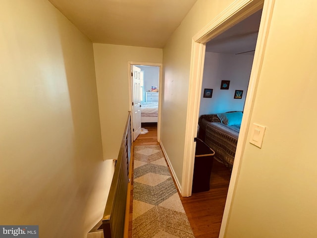 hallway with baseboards and wood finished floors