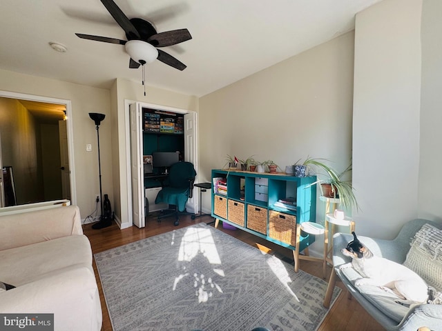 interior space with wood finished floors, baseboards, and ceiling fan