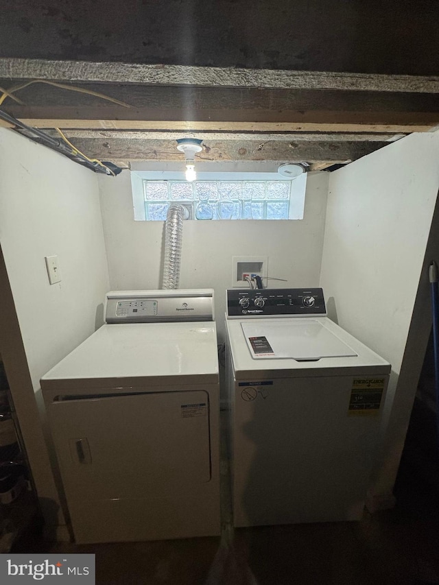 clothes washing area with a healthy amount of sunlight, laundry area, and washer and clothes dryer