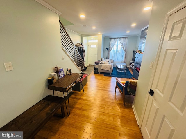 hall with stairs, crown molding, recessed lighting, and light wood-type flooring