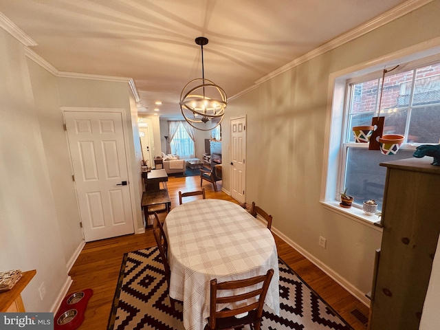 dining room featuring baseboards, dark wood finished floors, and crown molding