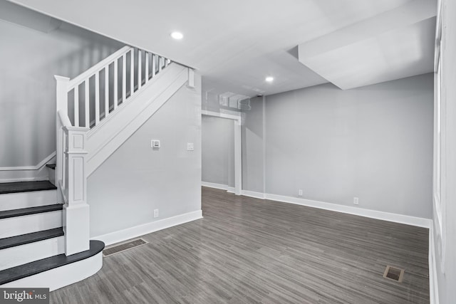 interior space featuring stairway, wood finished floors, visible vents, and baseboards