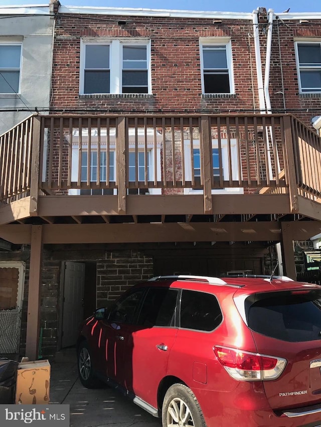 back of house featuring brick siding