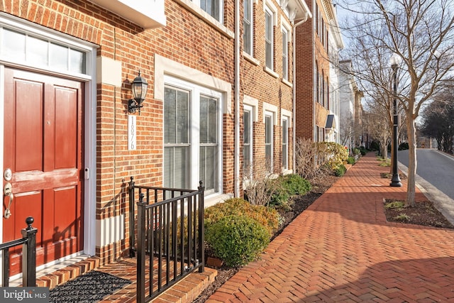 property entrance featuring brick siding