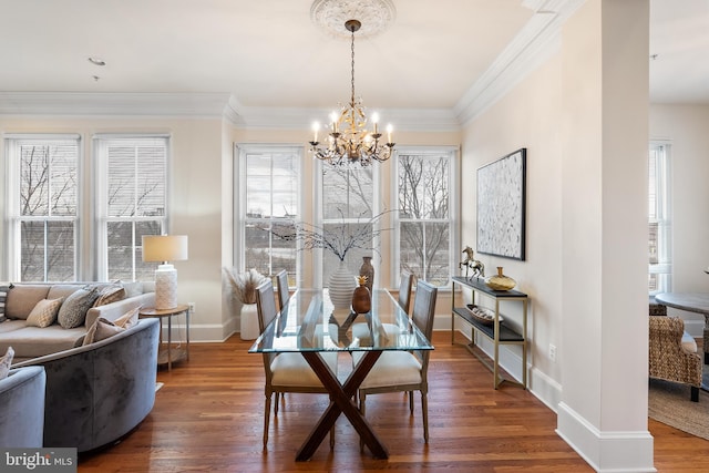 dining room with dark wood-style floors, baseboards, crown molding, and an inviting chandelier