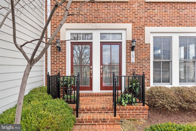 property entrance featuring brick siding