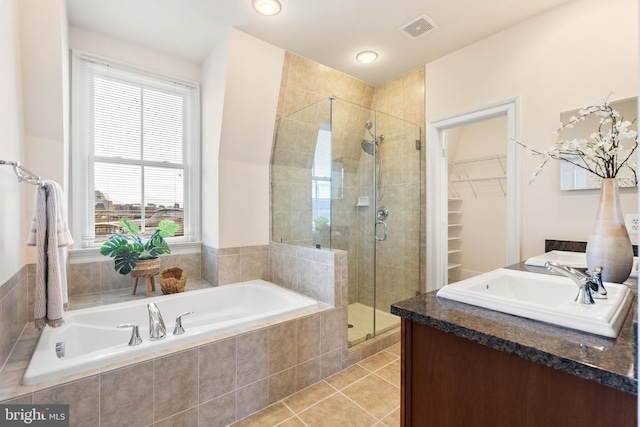 bathroom with visible vents, tile patterned floors, a garden tub, vanity, and a shower stall