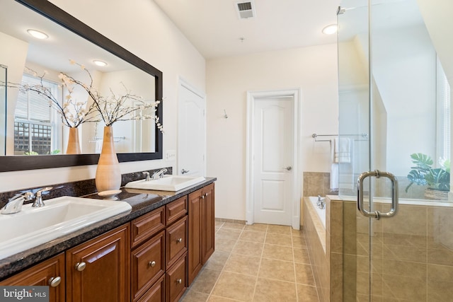 bathroom with tile patterned floors, a sink, visible vents, and a shower stall