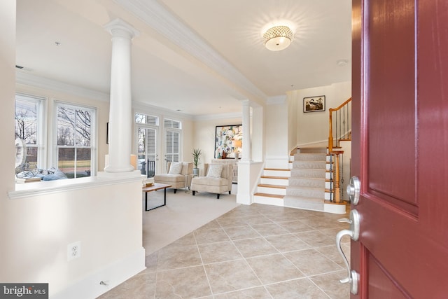 entrance foyer with decorative columns, visible vents, ornamental molding, light tile patterned flooring, and stairs