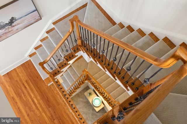 stairs featuring wood finished floors and baseboards