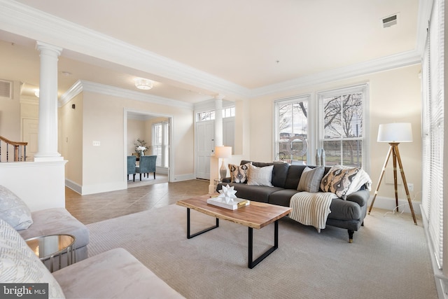 living area featuring crown molding, light tile patterned flooring, visible vents, and ornate columns