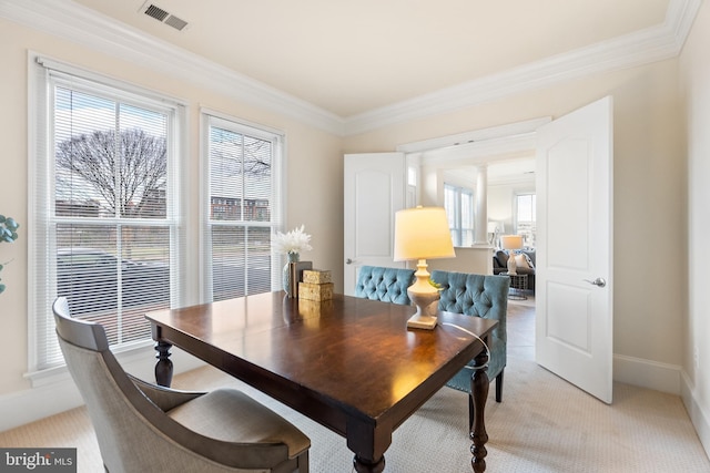 dining area with ornamental molding, a wealth of natural light, and visible vents