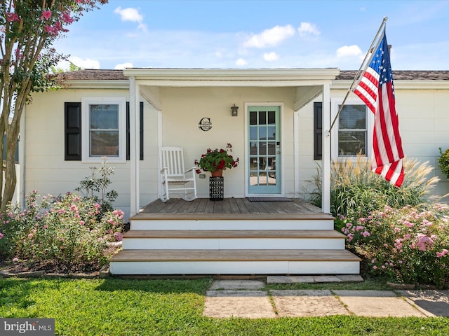 view of exterior entry with a porch