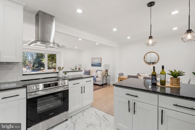 kitchen with island range hood, white cabinets, open floor plan, hanging light fixtures, and stainless steel electric range