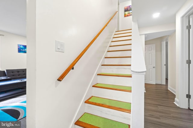 stairs featuring baseboards and wood finished floors