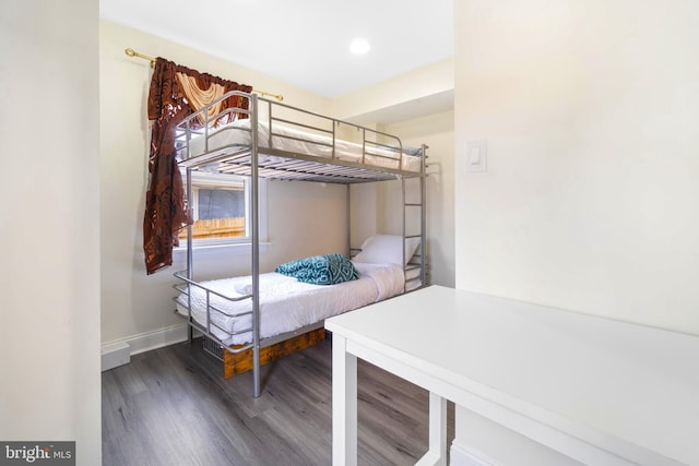 bedroom featuring dark wood-style flooring and baseboards