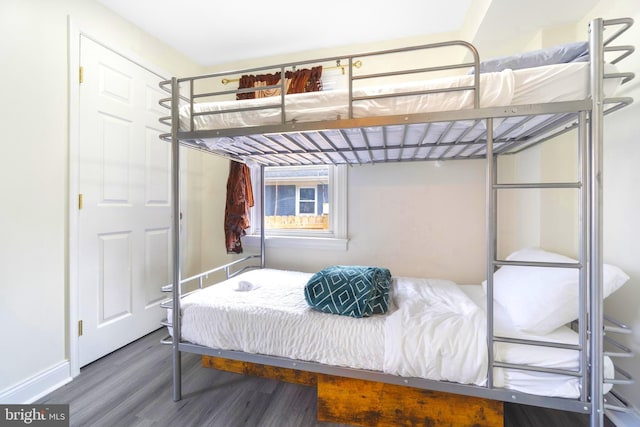 bedroom featuring baseboards and wood finished floors